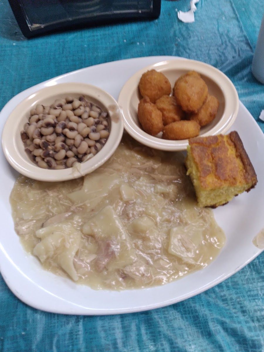 Chicken and dumplings with black-eyed peas, hushpuppies and a square of cornbread